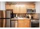 Efficient kitchen with stainless steel appliances, light wood cabinets, and dark granite countertops at 655 Four O Clock Rd # 104, Breckenridge, CO 80424