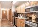 Convenient kitchen with stainless steel appliances and adjacent entry door, offering easy access to the rest of the house at 655 Four O Clock Rd # 104, Breckenridge, CO 80424