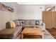 Comfortable living room featuring stone fireplace, wood floors and a large couch at 655 Four O Clock Rd # 104, Breckenridge, CO 80424