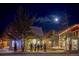 Charming street view of shops with festive lighting at night at 655 Four O Clock Rd # 104, Breckenridge, CO 80424