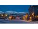 Charming street view with snowy mountains, vintage buildings, and inviting street lights in the winter evening at 655 Four O Clock Rd # 104, Breckenridge, CO 80424