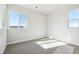Bright bedroom with carpeted floors and two large windows at 1727 Morgan Dr, Erie, CO 80516