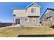 Back exterior view showcasing a two-story home with a patio, grill, and well-maintained lawn at 13464 E 107Th Ave, Commerce City, CO 80022