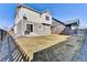 Large, sunny backyard with lawn, concrete patio, grill, and a charming fence, perfect for outdoor enjoyment at 13464 E 107Th Ave, Commerce City, CO 80022