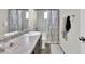 Bathroom featuring a shower-tub combo with a decorative curtain and a gray vanity at 13464 E 107Th Ave, Commerce City, CO 80022
