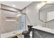 Modern bathroom boasts a gray vanity, marble countertop, and a walk-in shower with glass door at 13464 E 107Th Ave, Commerce City, CO 80022