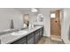 Spacious bathroom with dual sinks, a large mirror, and a separate tile shower at 13464 E 107Th Ave, Commerce City, CO 80022