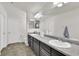 Bathroom with dual sinks, gray cabinets, and tile floors at 13464 E 107Th Ave, Commerce City, CO 80022