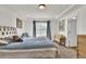 A primary bedroom offers tray ceilings, recessed lighting, plush carpet, and stylish, neutral paint at 13464 E 107Th Ave, Commerce City, CO 80022