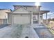 Charming gray two-story home with a two-car garage and inviting front porch at 13464 E 107Th Ave, Commerce City, CO 80022