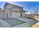 Gray two-story home features a two-car garage and a cozy covered front porch at 13464 E 107Th Ave, Commerce City, CO 80022
