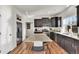 Modern kitchen featuring dark cabinetry, granite countertops, and stainless steel appliances for a chef's delight at 13464 E 107Th Ave, Commerce City, CO 80022