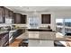 The kitchen features stainless steel appliances, granite countertops, dark wood cabinets and a breakfast bar with seating at 13464 E 107Th Ave, Commerce City, CO 80022
