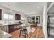A gorgeous, open-concept kitchen with a large island, granite counters, stainless appliances, and hardwood flooring at 13464 E 107Th Ave, Commerce City, CO 80022