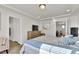 Bright main bedroom boasts recessed lighting, a large TV, and adjacent bath and closet doors at 13464 E 107Th Ave, Commerce City, CO 80022