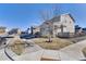 Quiet residential street featuring well-kept homes with landscaped yards and mature trees at 13464 E 107Th Ave, Commerce City, CO 80022