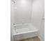 Bathroom with a white tiled tub-shower and chrome fixtures at 27699 E 7Th Ln, Aurora, CO 80018