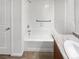 Bathroom with a tile surround tub and a granite countertop sink at 27699 E 7Th Ln, Aurora, CO 80018