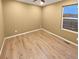 Bedroom featuring wood-look floors, warm-toned walls, a ceiling fan, and a bright window at 27699 E 7Th Ln, Aurora, CO 80018