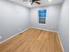 This bedroom features wood-look floors, light blue walls, and a window offering outside views at 27699 E 7Th Ln, Aurora, CO 80018