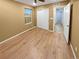 Bedroom with wood-look floors, closet, and a doorway leading to an adjacent room at 27699 E 7Th Ln, Aurora, CO 80018