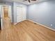Bedroom showcasing wood-look floors, light blue walls, and closet with sliding doors at 27699 E 7Th Ln, Aurora, CO 80018