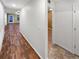 Hallway featuring hardwood floors and doors leading to the various rooms at 27699 E 7Th Ln, Aurora, CO 80018