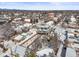 Residential neighborhood, displaying rooftops and tree coverage with a dusting of snow, and Denver cityscape in the distance at 1864 W 41St Ave, Denver, CO 80211