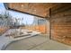 A view of the backyard featuring a wooden fence, concrete patio, and planters at 1864 W 41St Ave, Denver, CO 80211