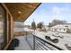 Balcony view showcases snow-covered neighborhood street in a charming winter landscape at 1864 W 41St Ave, Denver, CO 80211