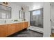 Modern bathroom featuring a glass shower, double sinks, and stylish vanity at 1864 W 41St Ave, Denver, CO 80211