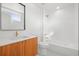 A contemporary bathroom features a modern vanity, tile flooring, and a bathtub with shower at 1864 W 41St Ave, Denver, CO 80211