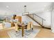 Contemporary dining room with wood table set for six, open staircase, and open-concept kitchen at 1864 W 41St Ave, Denver, CO 80211