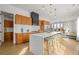 Bright kitchen featuring a large island, wood cabinets, stainless steel appliances, and a connected dining area at 1864 W 41St Ave, Denver, CO 80211