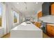 Bright kitchen featuring a large white quartz island with bar seating, wood cabinets, and stainless appliances at 1864 W 41St Ave, Denver, CO 80211