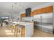 Modern kitchen featuring a large island with seating, stainless steel appliances, and wood cabinetry at 1864 W 41St Ave, Denver, CO 80211