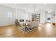 Sunlit living room with a cozy fireplace, comfortable seating, and a stylish area rug on wood floors at 1864 W 41St Ave, Denver, CO 80211