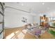 Bright, open living area with wood floors, modern furnishings, and a unique overhead garage door feature at 1864 W 41St Ave, Denver, CO 80211