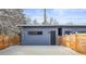 An outbuilding in the backyard featuring wood fence and snow covered ground at 1864 W 41St Ave, Denver, CO 80211