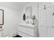 Bright bathroom featuring a modern white vanity with ample storage and a mirrored medicine cabinet at 509 Paiute Rd, Evergreen, CO 80439