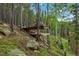 Beautiful multi-level deck nestled in the trees for peaceful, private outdoor enjoyment at 509 Paiute Rd, Evergreen, CO 80439