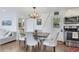 Inviting dining area with modern lighting and access to the kitchen at 509 Paiute Rd, Evergreen, CO 80439