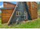 Exterior of a home with wood siding, an A frame portion, a door, and grass at 509 Paiute Rd, Evergreen, CO 80439