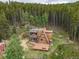 An aerial shot of the cabin with a view of its large decks and wooden exterior at 509 Paiute Rd, Evergreen, CO 80439