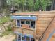 An eye-level view of the exterior showcasing a deck outside a bedroom of this charming cabin at 509 Paiute Rd, Evergreen, CO 80439