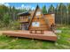 Stunning A-frame home with a large deck and a forest backdrop at 509 Paiute Rd, Evergreen, CO 80439