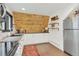 Modern kitchen featuring white cabinets and a wood accent wall at 509 Paiute Rd, Evergreen, CO 80439