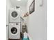 Laundry room featuring stacked washer and dryer, storage cart, and white walls at 509 Paiute Rd, Evergreen, CO 80439