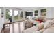 Bright living room with hardwood floors, white couch, and mountain views at 509 Paiute Rd, Evergreen, CO 80439