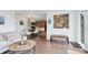 Cozy living space featuring a view to the kitchen and a rustic accent wall at 509 Paiute Rd, Evergreen, CO 80439
